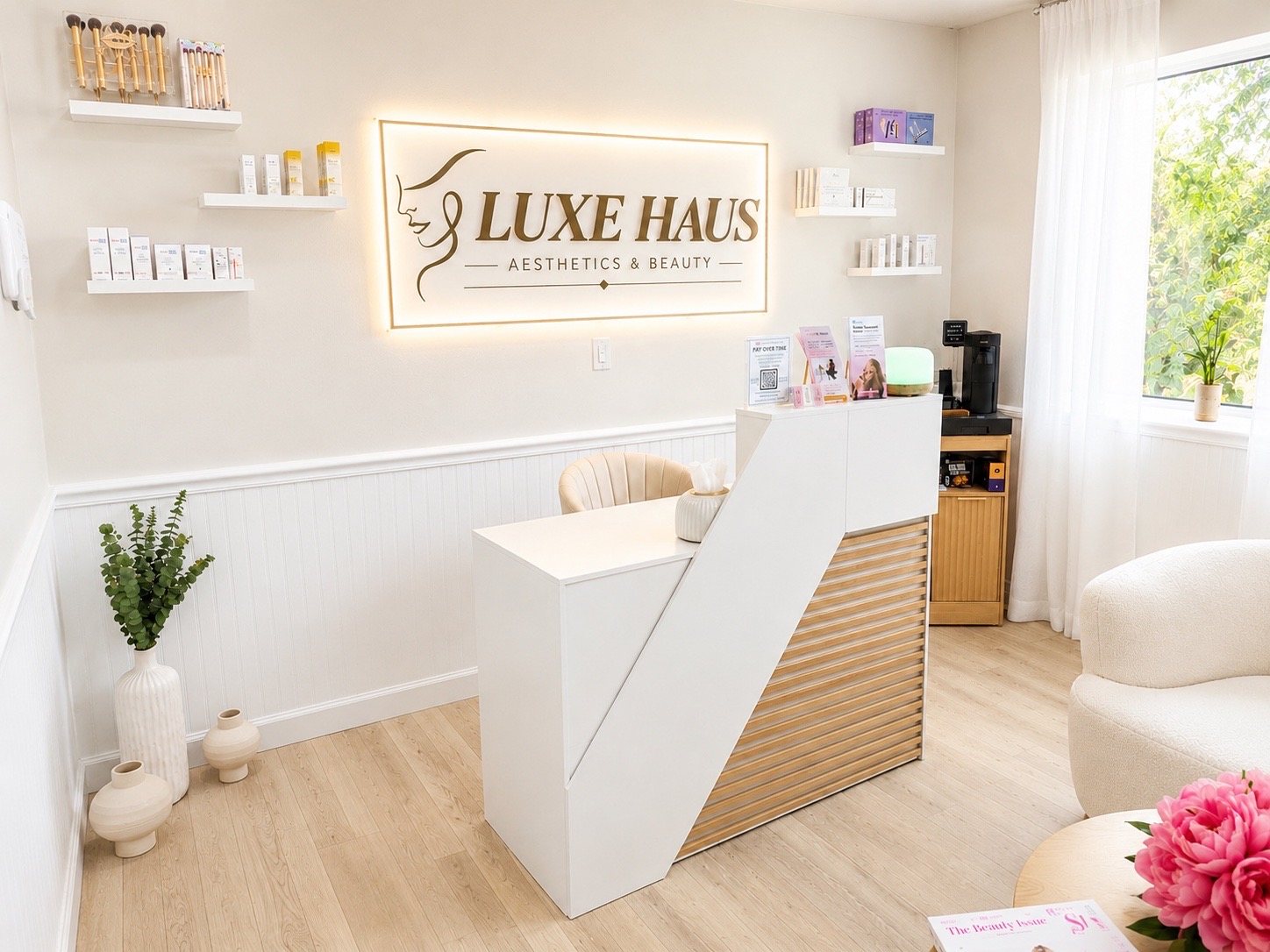 Reception with the illuminated Luxe Haus brand sign.